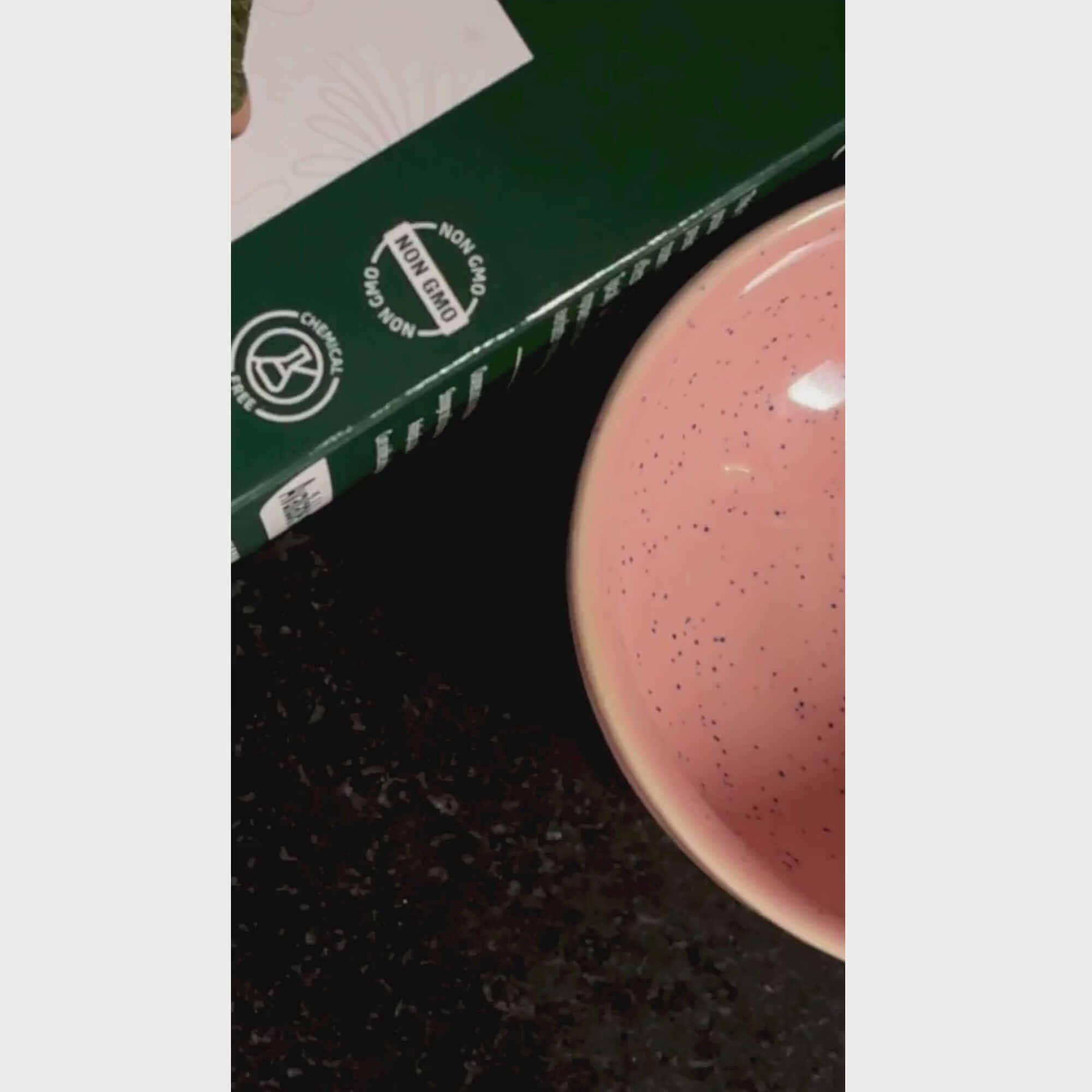 Neem Leaf Powder box with eco-friendly labels next to a pink speckled bowl on a dark surface.